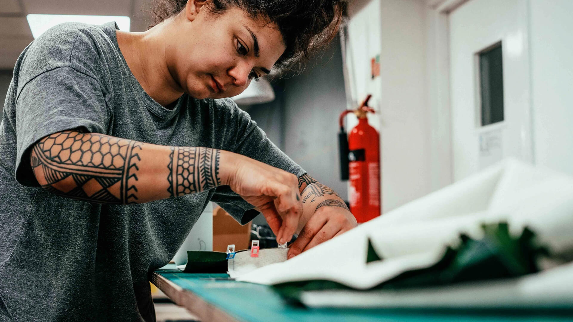 Person working closely with fabric measurements