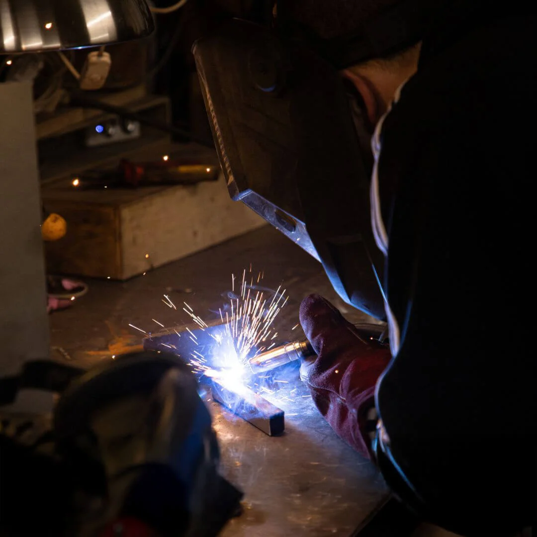 Close up of sparks flying as person welds piece of metal
