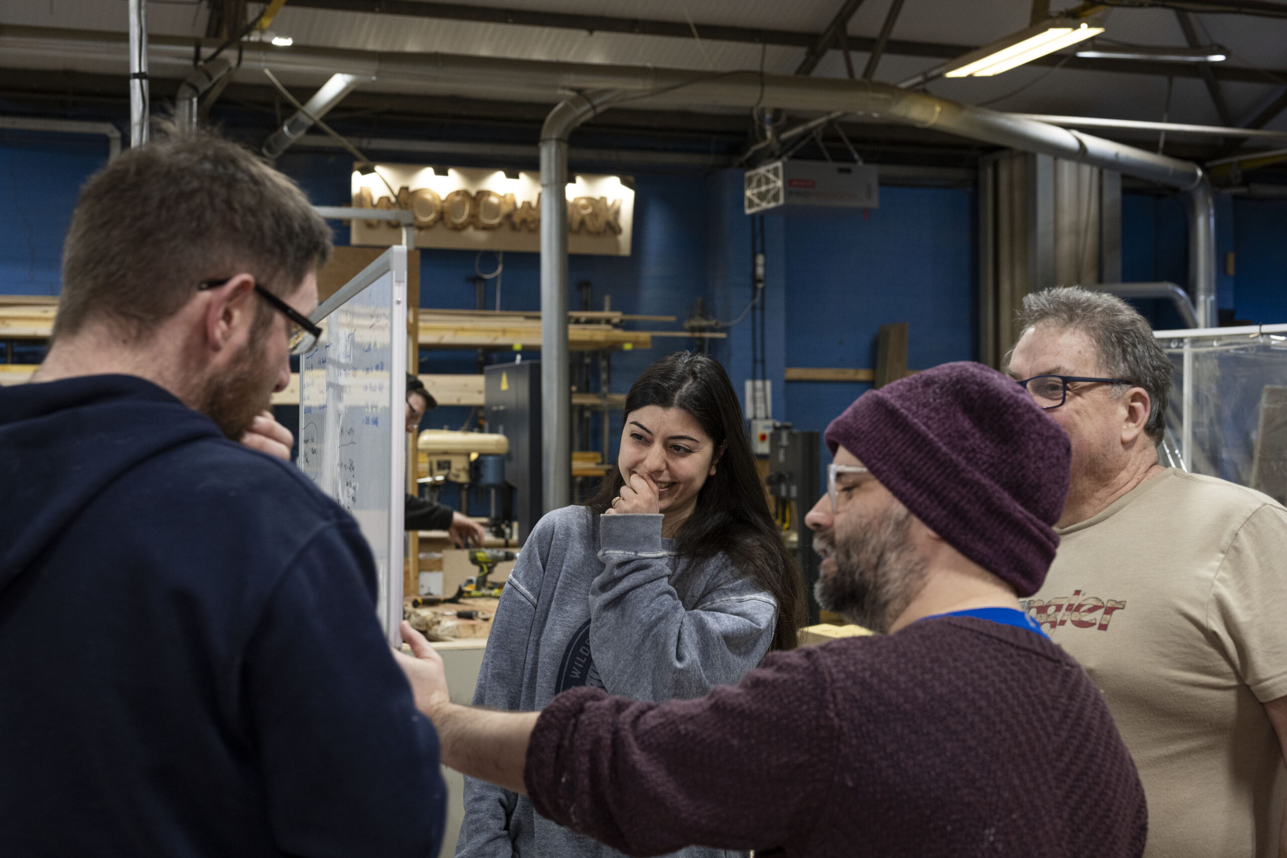 EOW resident members discussing a project in the workshop
