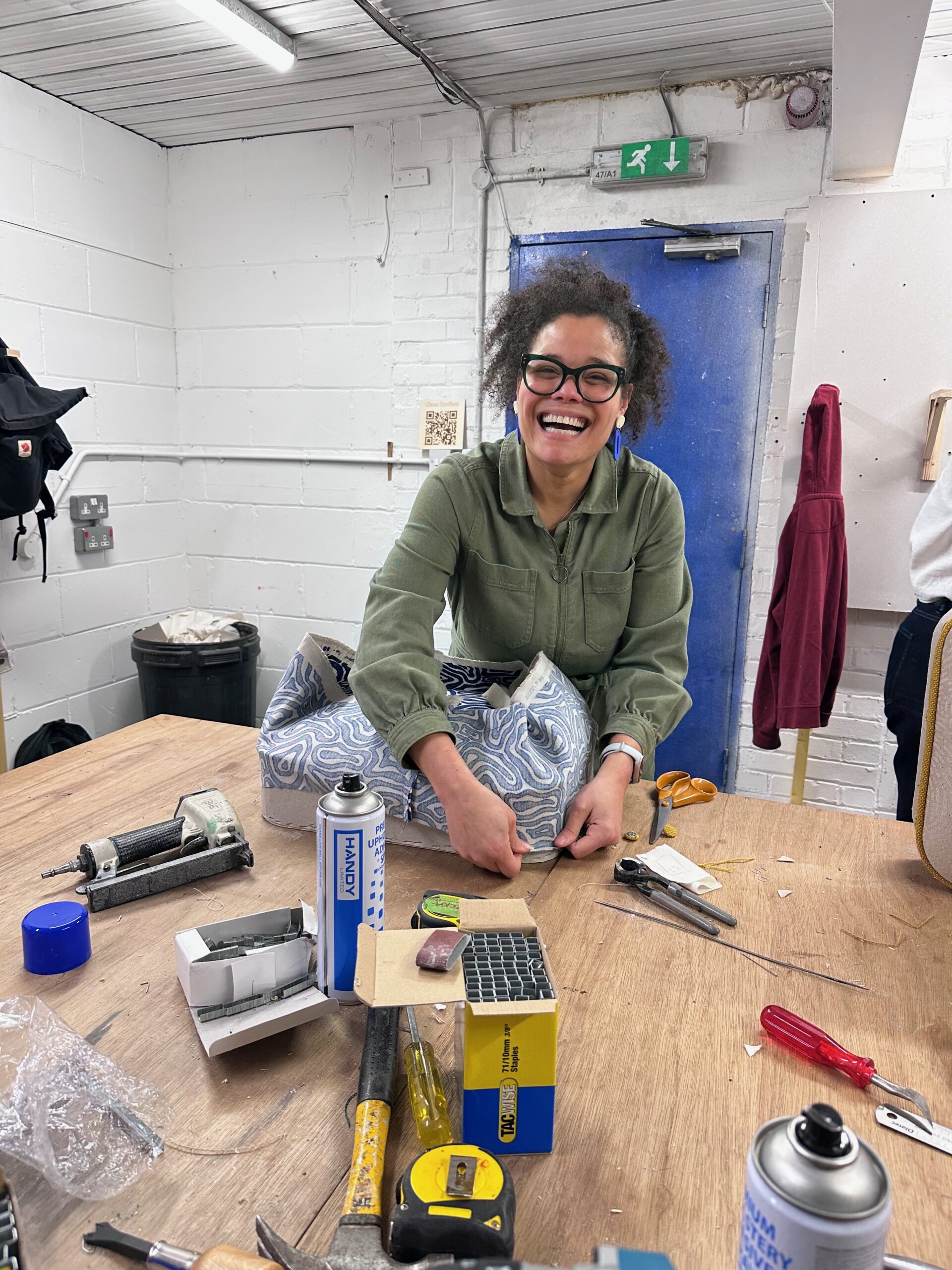 EOW director Tash learning upholstery in the workshop