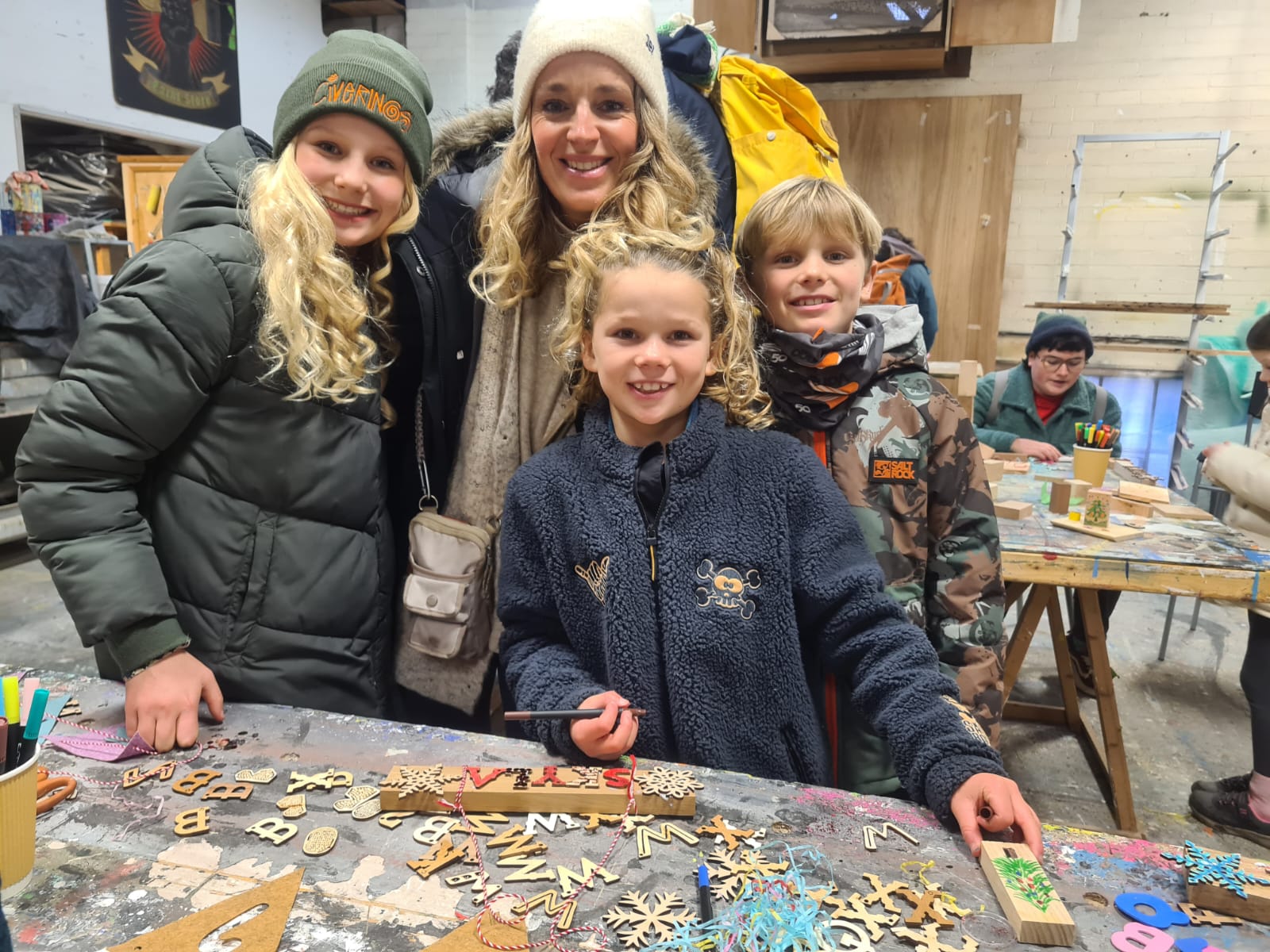 Family enjoying the arts and crafts table during EOW's Family Day