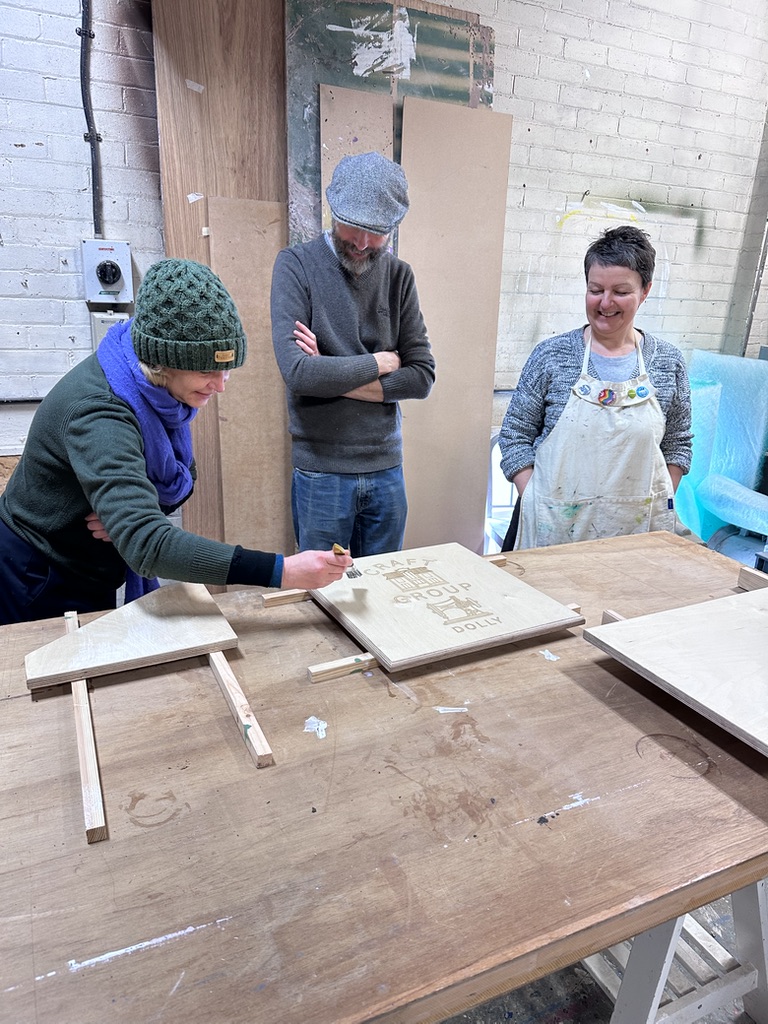 Members of Duncan Place creating a custom sewing table in the workshop.