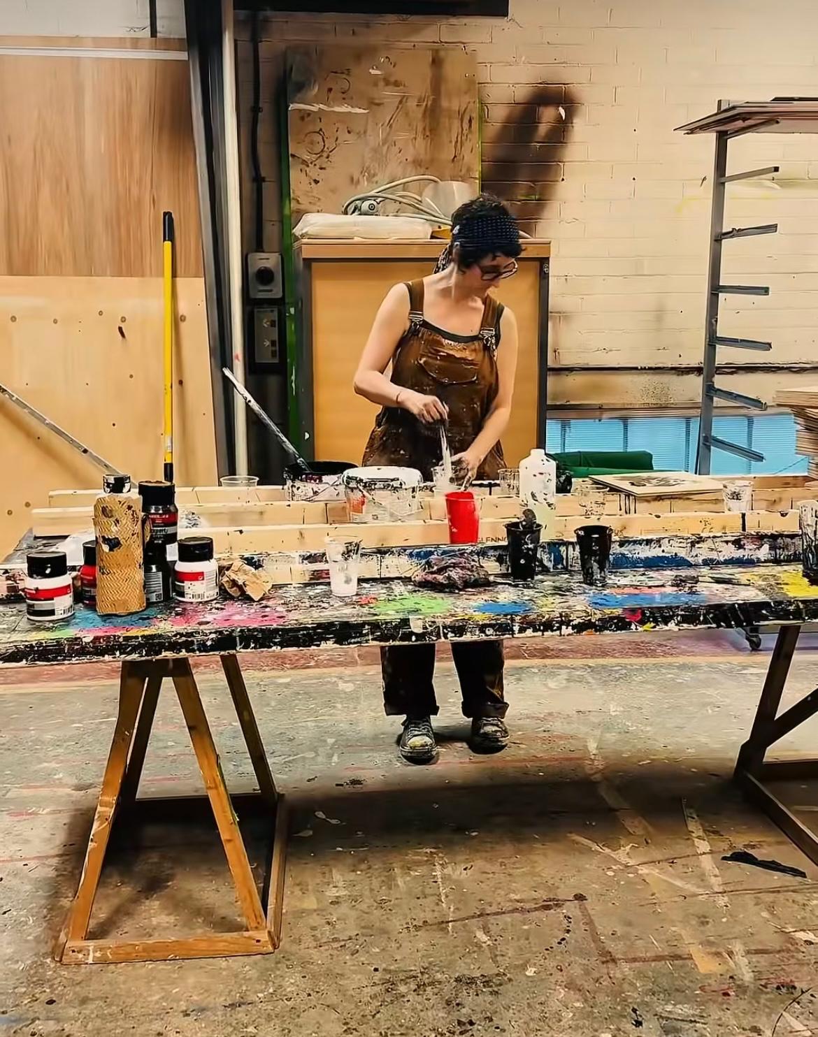 Scenic artist completing a project on the paint floor