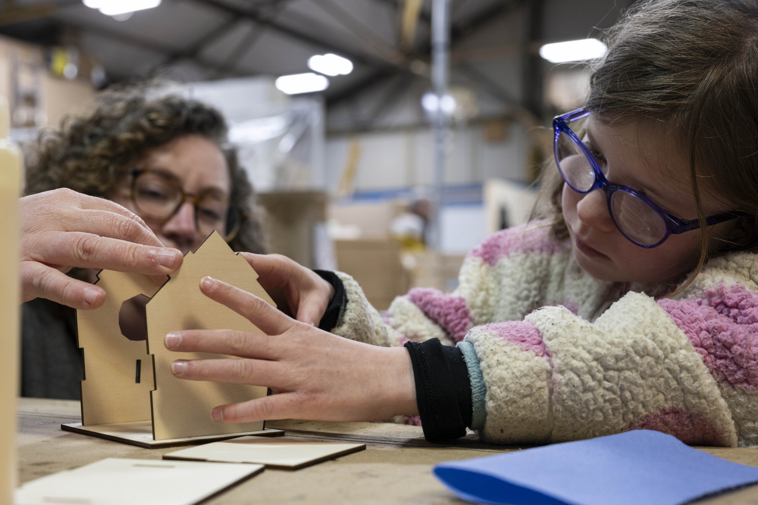 Child making a birdhouse during Family Day