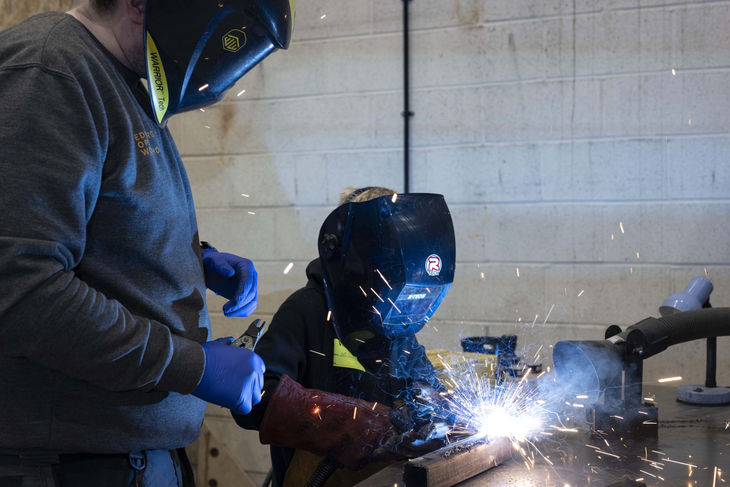 Child learning to weld at Family Day