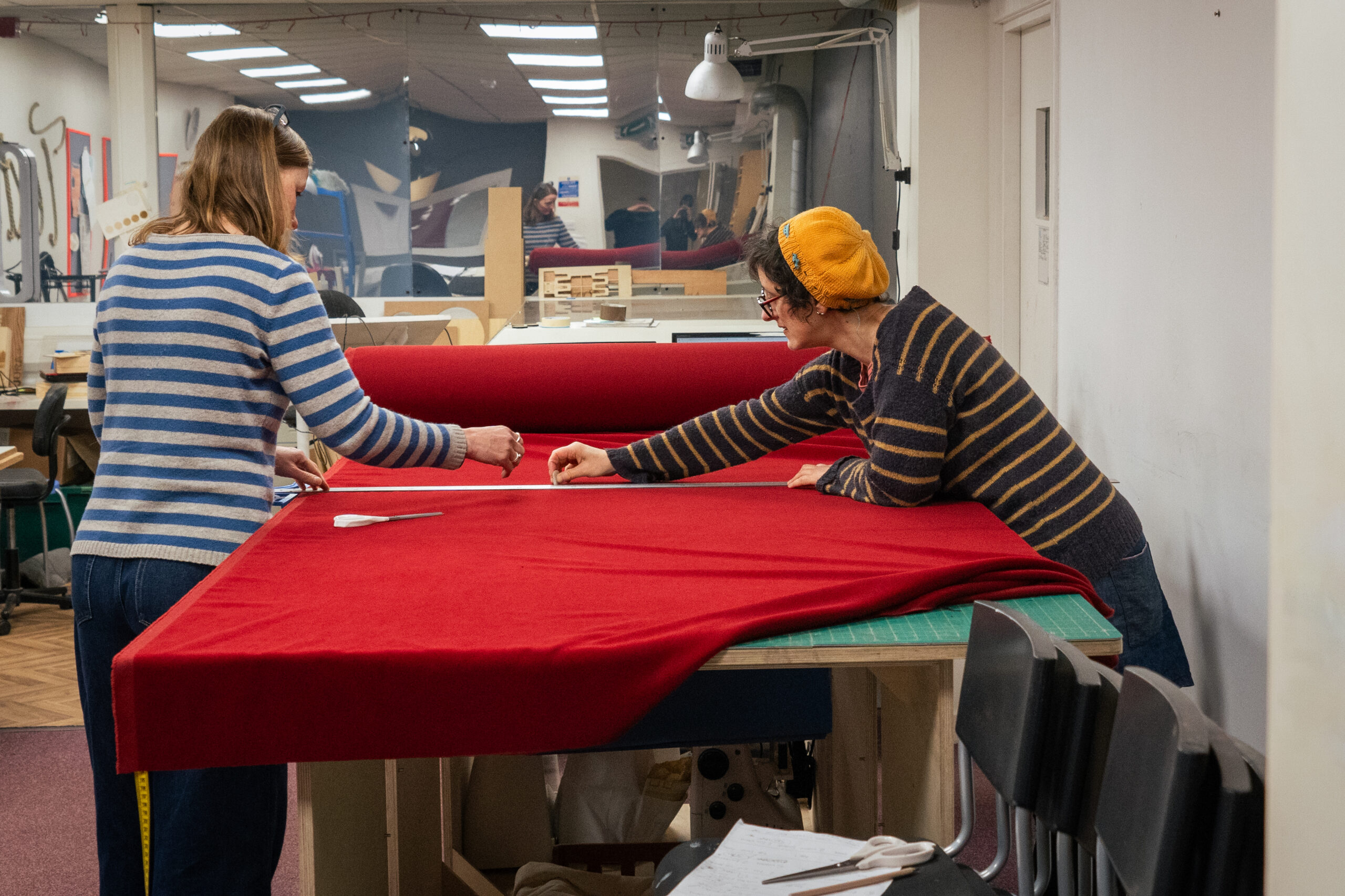 People cutting material in the EOW textiles studio