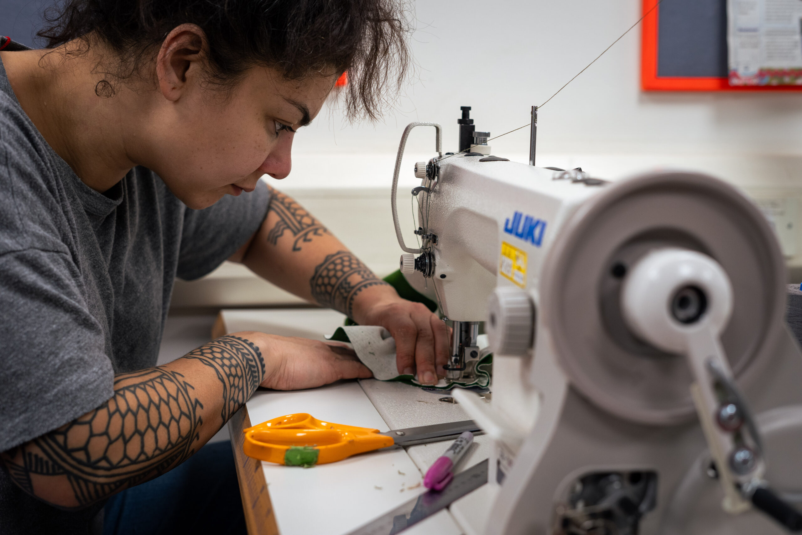 Person using the sewing machine in the textiles room