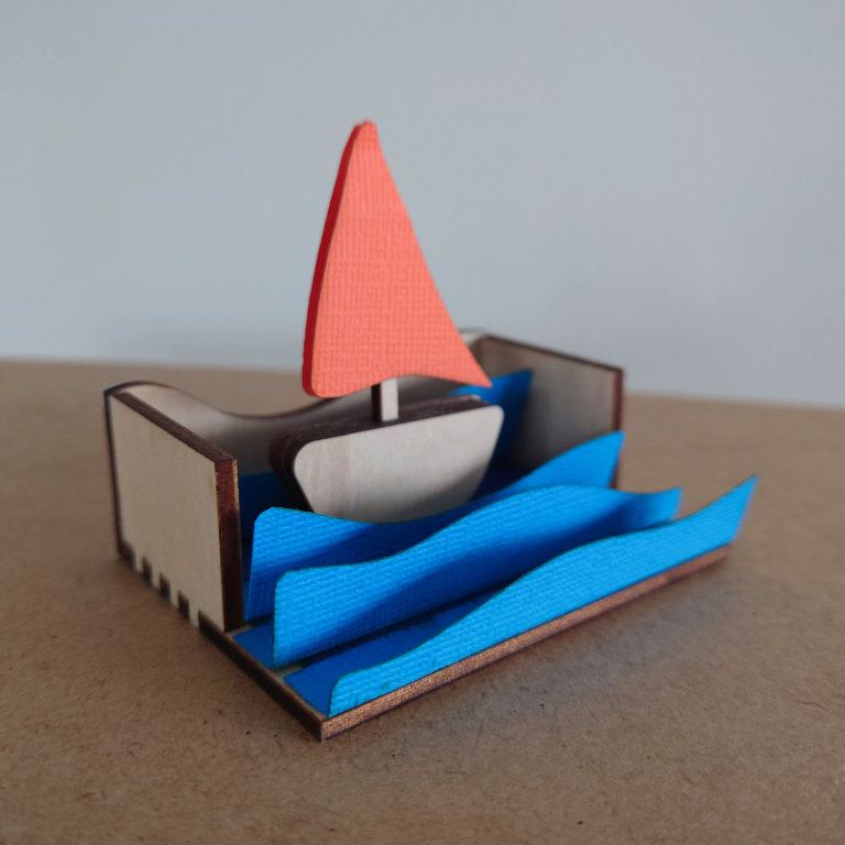 Laser cut sail boat model made from paper and wood