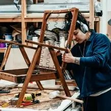 Person assembling bespoke chair in workshop