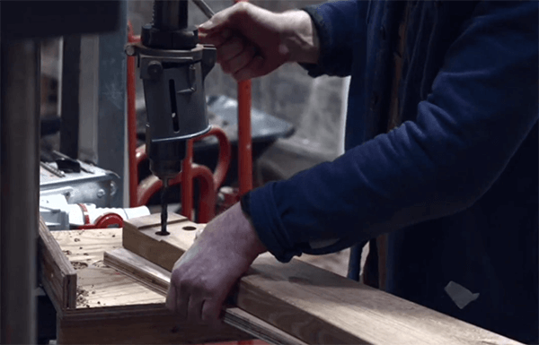 woodwork-bay-poster-image Person drilling wood in Woodworking area